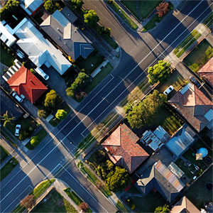 The Connection. A suburban neighborhood seen from above. Photo Credit: Tom Rumble on Unsplash [https://unsplash.com/photos/7lvzopTxjOU]