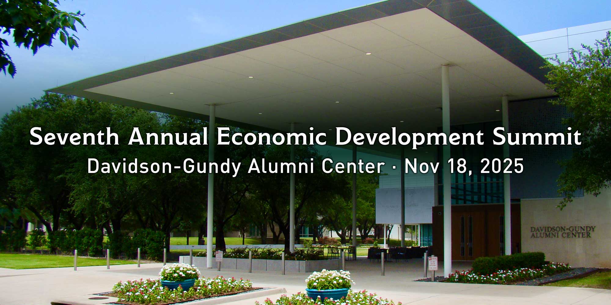 Text which reads, “Seventh Annual Economic Development Summit. Davidson-Gundy Alumni Center. Nov 18, 2025.#8221; In the background is the Davidson-Gundy Alumni Center on the campus of The University of Texas in Dallas.