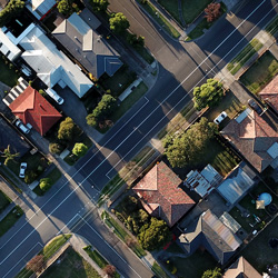 A suburban neighborhood seen from above. Photo Credit: Tom Rumble on Unsplash [https://unsplash.com/photos/7lvzopTxjOU]