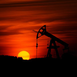An oil well at sunset. Photo Credit: Zbynek Burival on Unsplash [https://unsplash.com/photos/GrmwVnVSSdU]