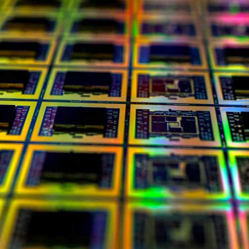 A silicon wafer. Photo Credit: 2022 Maxence Pira on Unsplash [https://unsplash.com/photos/a-close-up-of-a-computer-aNaq4lbX99E]