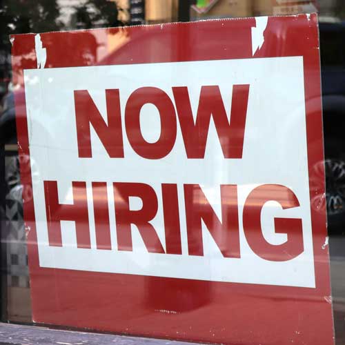 DFW Labor Market Update. A sign in a window that reads “Now Hiring”. Photo Credit: 2025 Nathan Sack on Unsplash [https://unsplash.com/photos/a-now-hiring-sign-hangs-in-a-store-window-UQ716eQauSw]