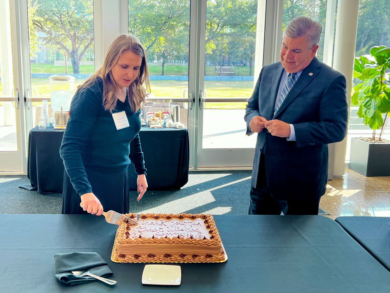 From left: Jenny Mizutowicz, outgoing director for Economic Development, shares a farewell slice of cake with Paul Voelker, mayor for the city of Richardson.