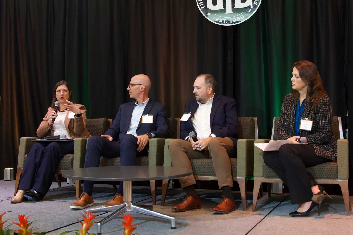 From left: Lori Pampell Clark, senior program manager of Clean Fleet and Energy Improvements and DFW Clean Cities Director for the North Central Texas Council of Governments, answers an audience question during the panel on “Paving the Path to Success” while the rest of the panel — Billy George, deputy director of Water and Wastewater for the North Texas Municipal Water District; Wilson Peppard, director of economic development for Oncor Electric Delivery; Dee Leggett, executive vice president / chief development officer for Dallas Area Rapid Transit — prepare to respond in turn.